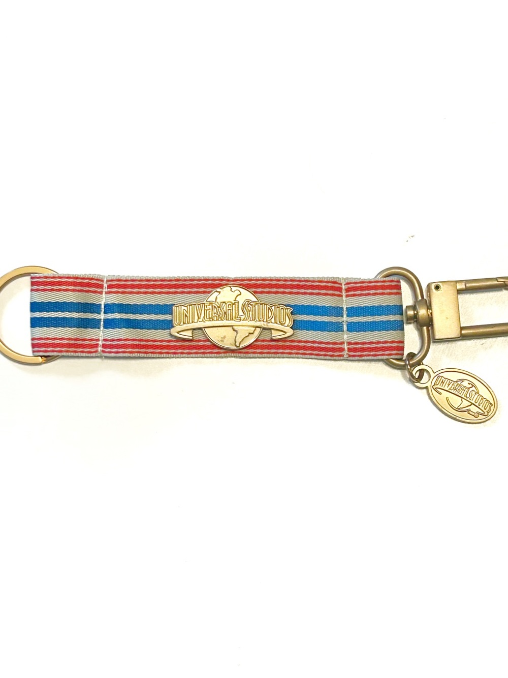 Vintage Universal Studios Striped Ribbon Fabric Keychain Fob Gold Tone Red Blue